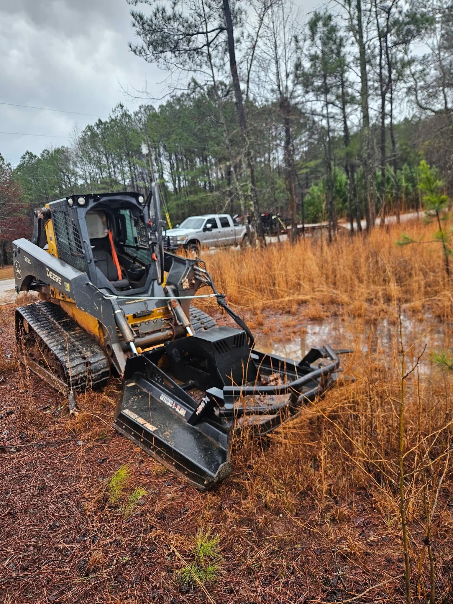 Tracked skid steer with mulcher attachment